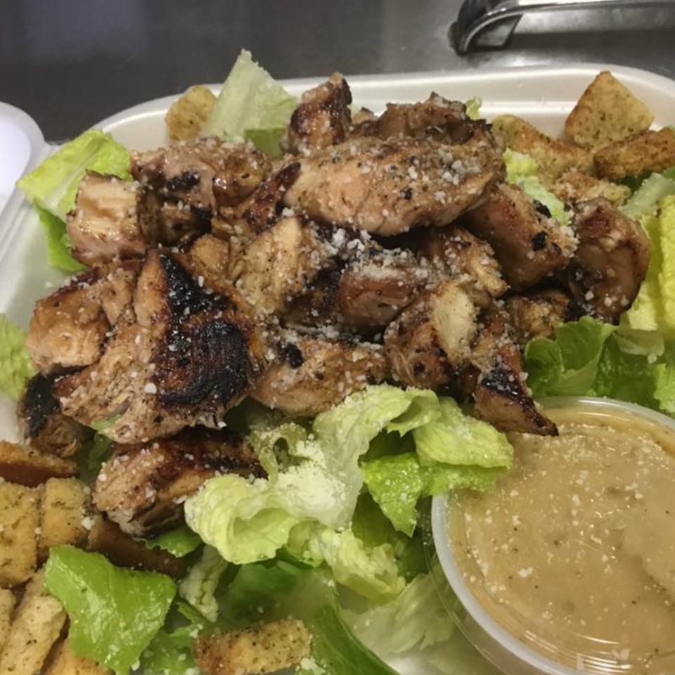 Grilled chicken Caesar salad with croutons and dressing from Vito's Bistro.